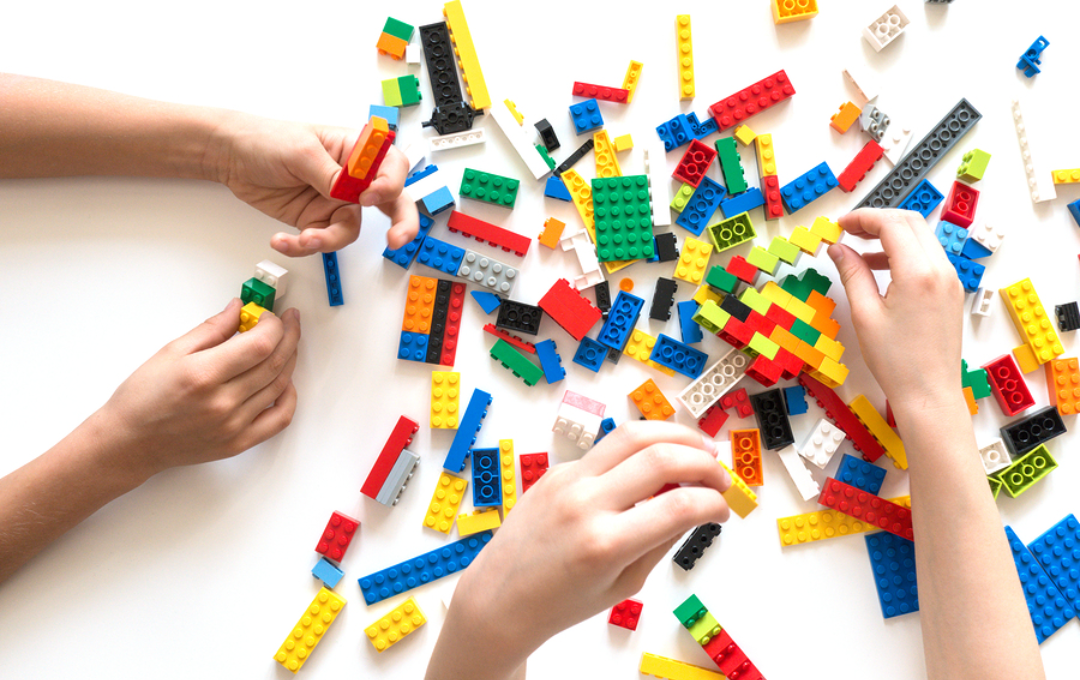 children's hands putting together LEGO® Bricks