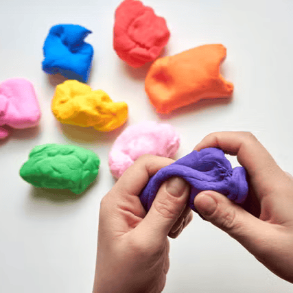 hands playing with clay